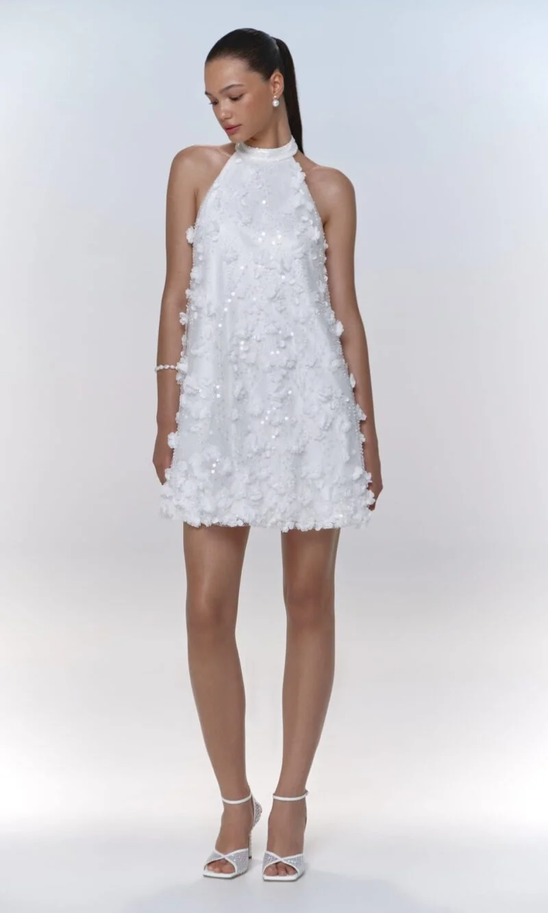 Chic backless mini dress with lace and 3D flower accents, featuring a bow